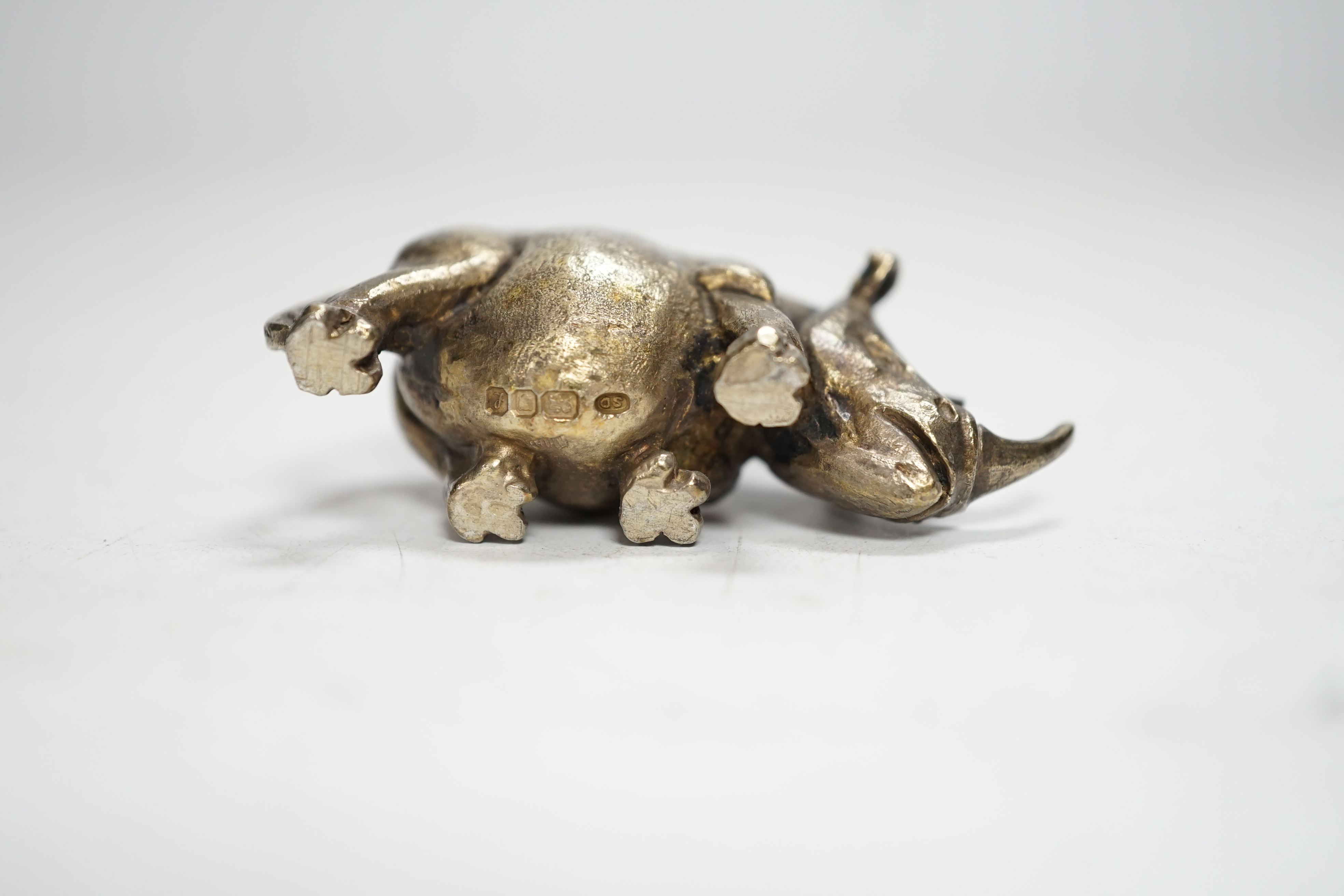 An Elizabeth II silver miniature model of a rhinoceros, by Stuart Devlin, London, 1985, length 55mm.